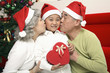 Foto: Senior man and senior woman kissing boy Senior man and senior woman kissing boy