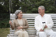 Foto: Senior man and senior woman relaxing on the swing Senior man and senior woman relaxing on the swing