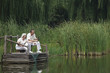 Senior couple sitting on a dock fishing