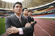 Business people standing in a row on running track