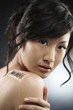 Woman with bar code on the back of her shoulder
