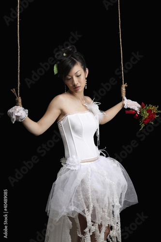 Photo: Woman puppet tied with rope Woman puppet tied with rope