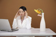 Woman looking at laptop with hands on her head