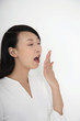 Woman yawning with her eyes closed