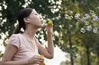 Woman playing with soap bubbles