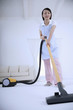Woman vacuuming the floor