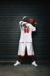Man holding basketball pointing at the camera