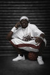 Man sitting on basketball talking on the phone