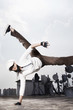 Young woman making a breakdance move