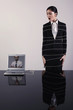 Businesswoman tied up with rope connected to laptop