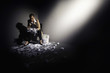 Businesswoman sitting on chair holding shredded papers