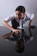 Businesswoman crouching on glass table