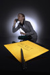Photo: Secret envelope in the foreground with businesswoman talking on the phone in the background Secret envelope in the foreground with businesswoman talking on the phone in the background
