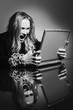 Businesswoman with chained hands using laptop