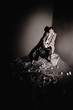 Businesswoman sitting on chair holding shredded and crumpled papers
