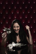 Woman dining on a plate of bank notes