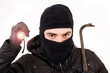 Thief with flashlight and crowbar, isolated in white Thief with flashlight and crowbar, isolated in white