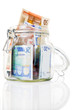 Glass money jar of Euro banknotes