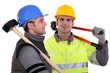 Two builders with tools