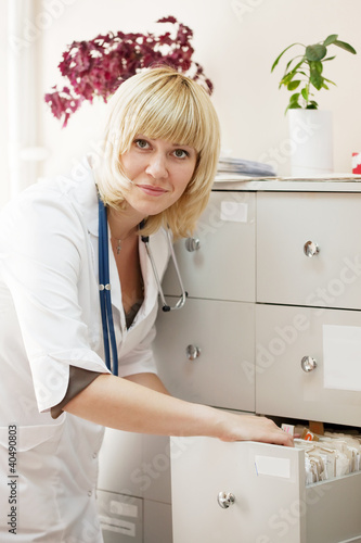 Photo: doctor searching for patient's records doctor searching for patient's records