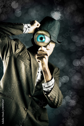 Photo: Man Looking Through Magnifying Glass Man Looking Through Magnifying Glass