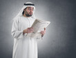 arabian businessman shocked while reading newspape