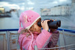 Little girl looks through binoculars