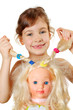 Little girl shows dolls braids, which herself braided isolated