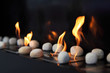 White circular stones and beautiful yellow flames in fireplace