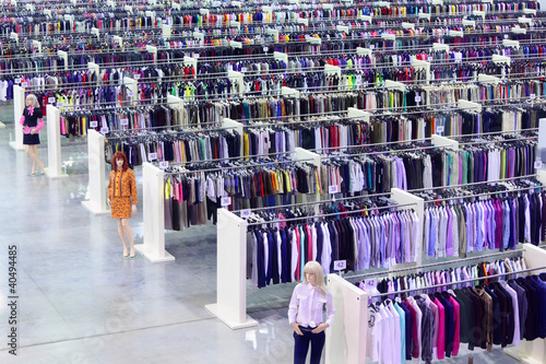 Photo: Big clothing store, dummies and many rows with hangers Big clothing store, dummies and many rows with hangers