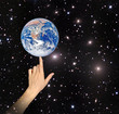 Planet earth on finger.Elements of this image furnished by NASA