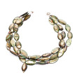 Necklace with green and gold oval stones on white
