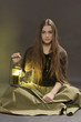 The girl with a lantern sits on a black background
