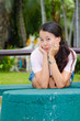 asian woman sitting and smile on bench