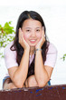 asian woman sitting and smile on bench