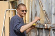 Man painting gate  Ukraine