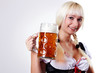 Young woman in folk costume holding a glass of beer
