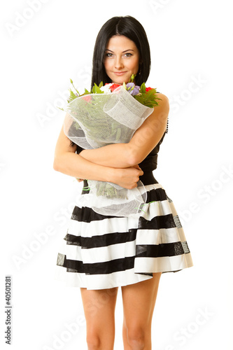 Photo: pretty woman holding flowers against white background pretty woman holding flowers against white background