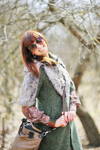 Photo: Fashionable smiling woman with sunglasses outdoors Fashionable smiling woman with sunglasses outdoors