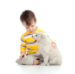 Photo: cute child playing with a puppy cute child playing with a puppy