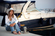 Beautiful woman in front of the yacht
