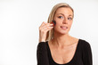 Pretty blonde woman putting on face powder
