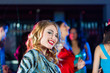 Party people dancing in disco or club