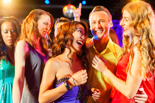 Photo: Party people dancing in disco or club Party people dancing in disco or club