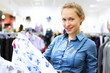 Woman in a shop buying clothes