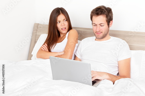 Photo: Couple with laptop in bed Couple with laptop in bed