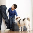 Boy looking at his father while trying to carry tollbox