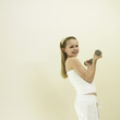 Little girl lifting dumbbell