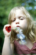 Little girl playing bubbles