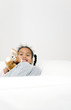 Girl resting on the couch with her plush toy